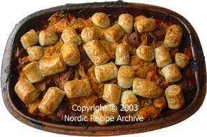 Baked clay pot with sausages